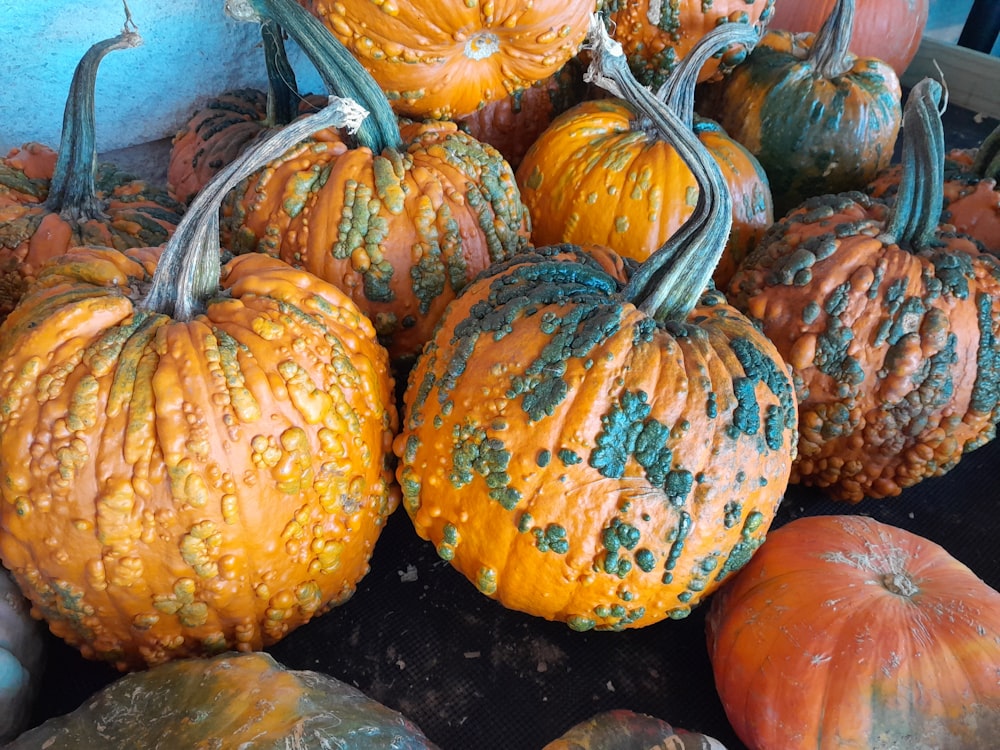 a pile of pumpkins sitting next to each other