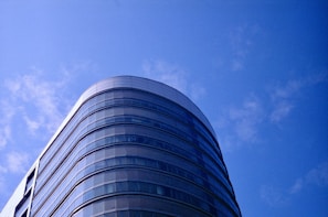 A panoramic view of the Godrej Regal Pavilion exterior showcasing its contemporary architecture against a clear blue sky