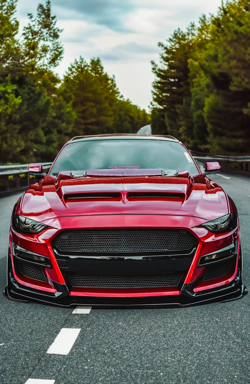 a red sports car parked on the side of a road