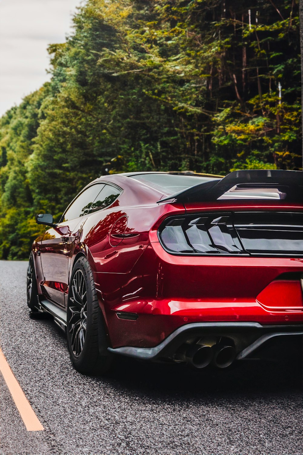 a red sports car parked on the side of the road