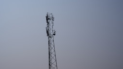 a tall tower with a cell phone on top of it