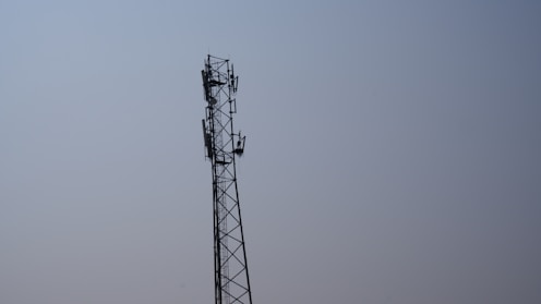 a tall tower with a cell phone on top of it