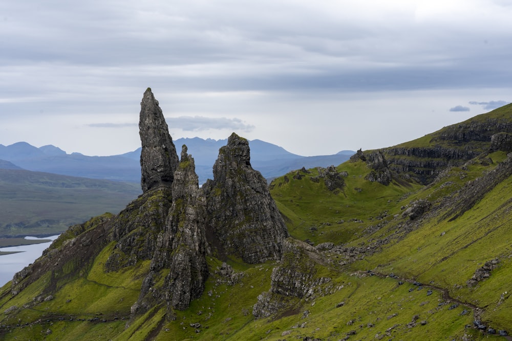 a large rock formation in the middle of a green field