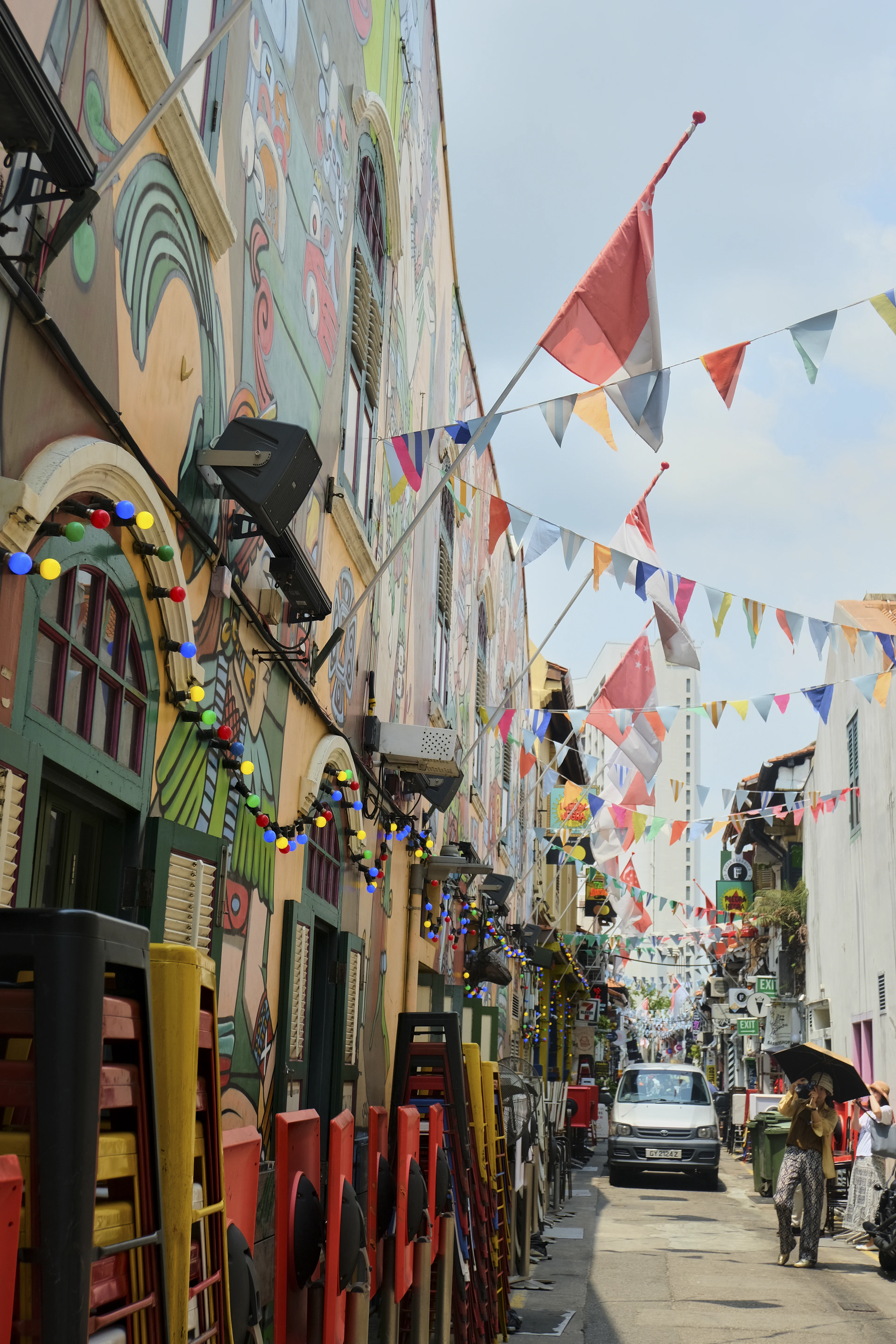 A narrow, mural-covered lane strung with colourful bunting in Kampong Glam