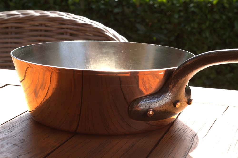 a wooden bowl sitting on top of a wooden table