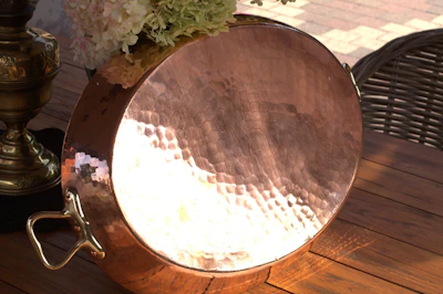 Elegant copper home decor piece with minimalist design placed on a dark matte surface