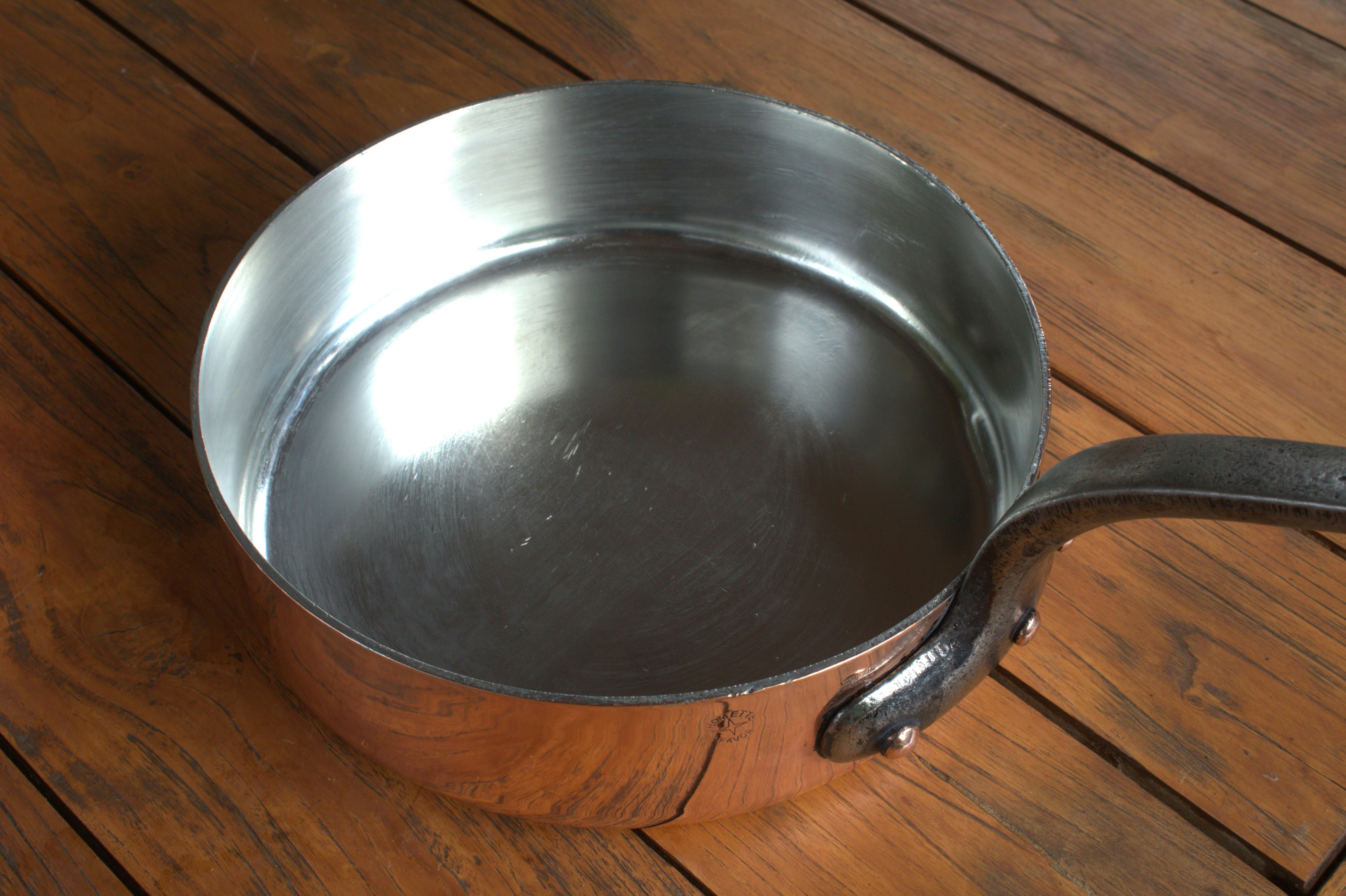 a metal pan sitting on top of a wooden table