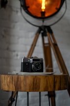 A warm studio corner with soft natural light and a vintage camera on a wooden table.