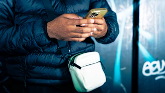 a man holding a cell phone in his hand