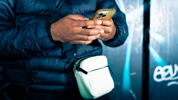 a man holding a cell phone in his hand