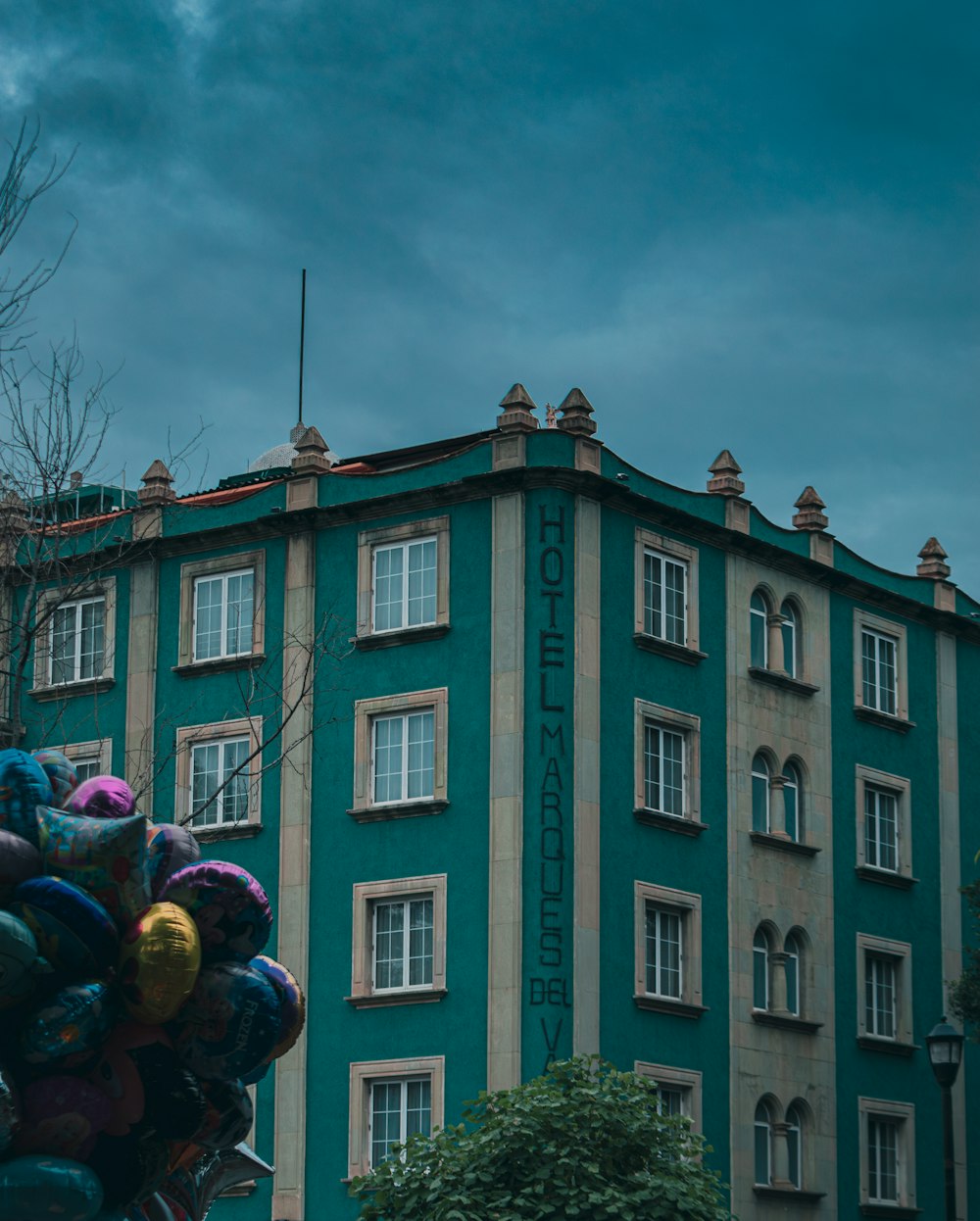a tall building with a bunch of balloons in front of it