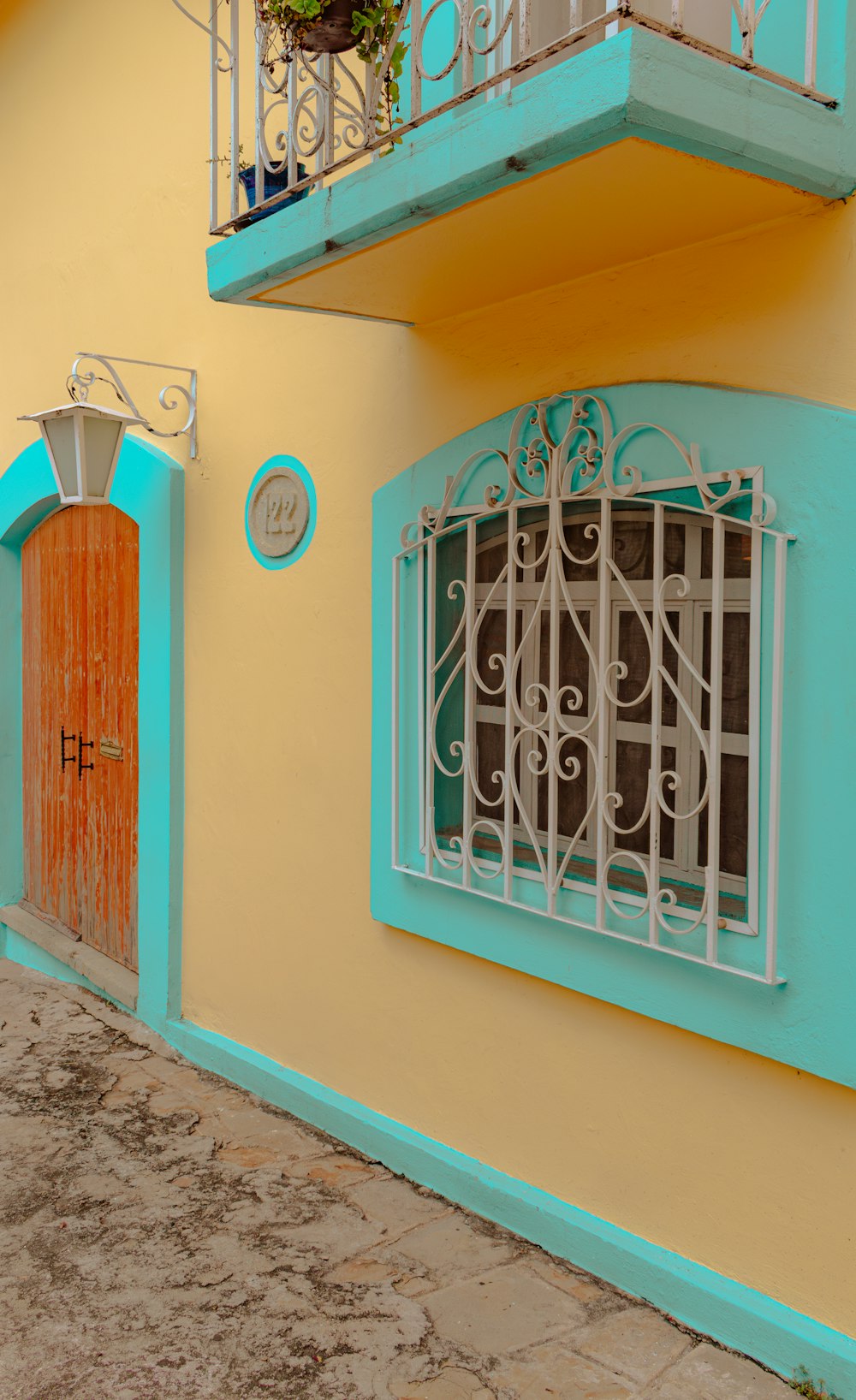 a blue and yellow building with a red door