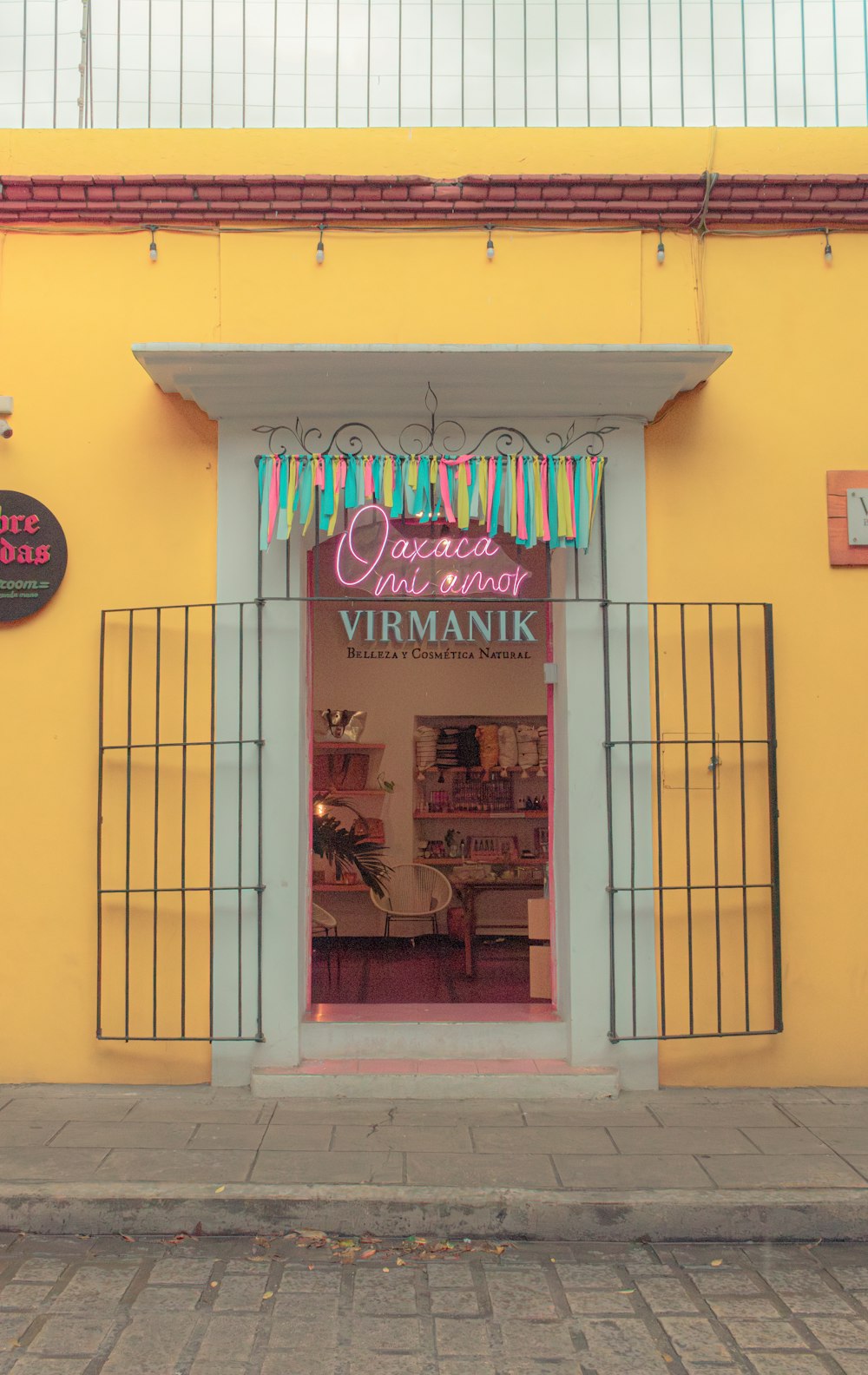 a yellow building with a sign on the front of it