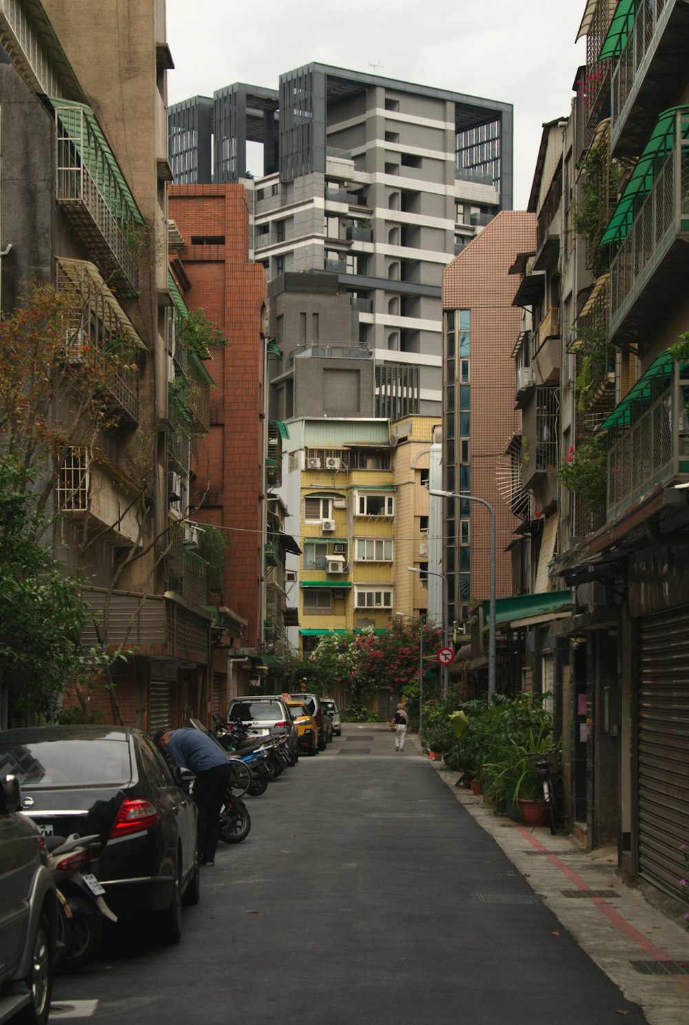 a narrow city street lined with tall buildings