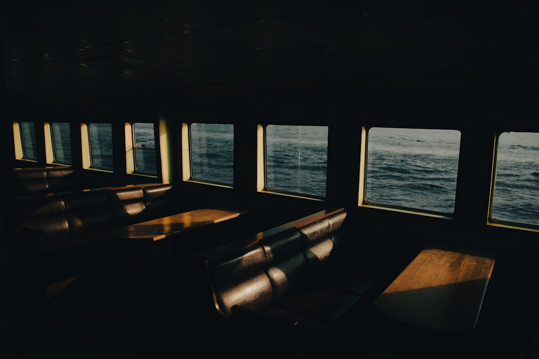 a row of benches sitting in front of a window,