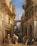 A bustling Middle Eastern street scene features a variety of people in traditional attire. An intricate architectural setting with arches and balconies frames the view. The scene is lively, with people engaging with each other and moving through the space. A notable tower rises in the background under a clear blue sky.