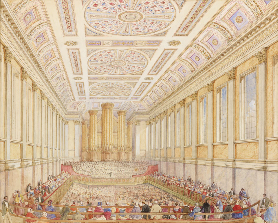 Grand, ornate room with high ceilings and intricate decorations features a stage seating area