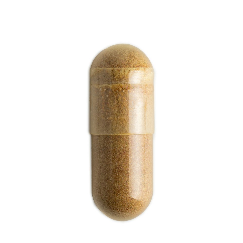 a brown pill pill with a white background