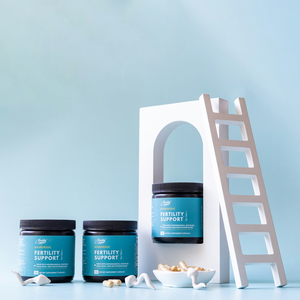 a set of three jars of sea salt next to a ladder