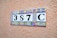 A decorative ceramic tile display with a number '387C' set against a textured terracotta-colored wall. Each tile features ornate patterns with blue, yellow, and red colors.