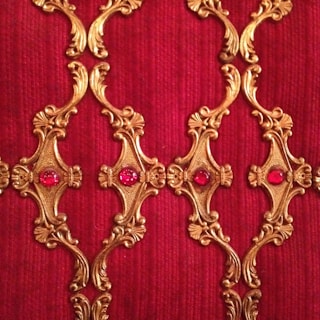 Richly textured artwork featuring deep reds and gold accents.