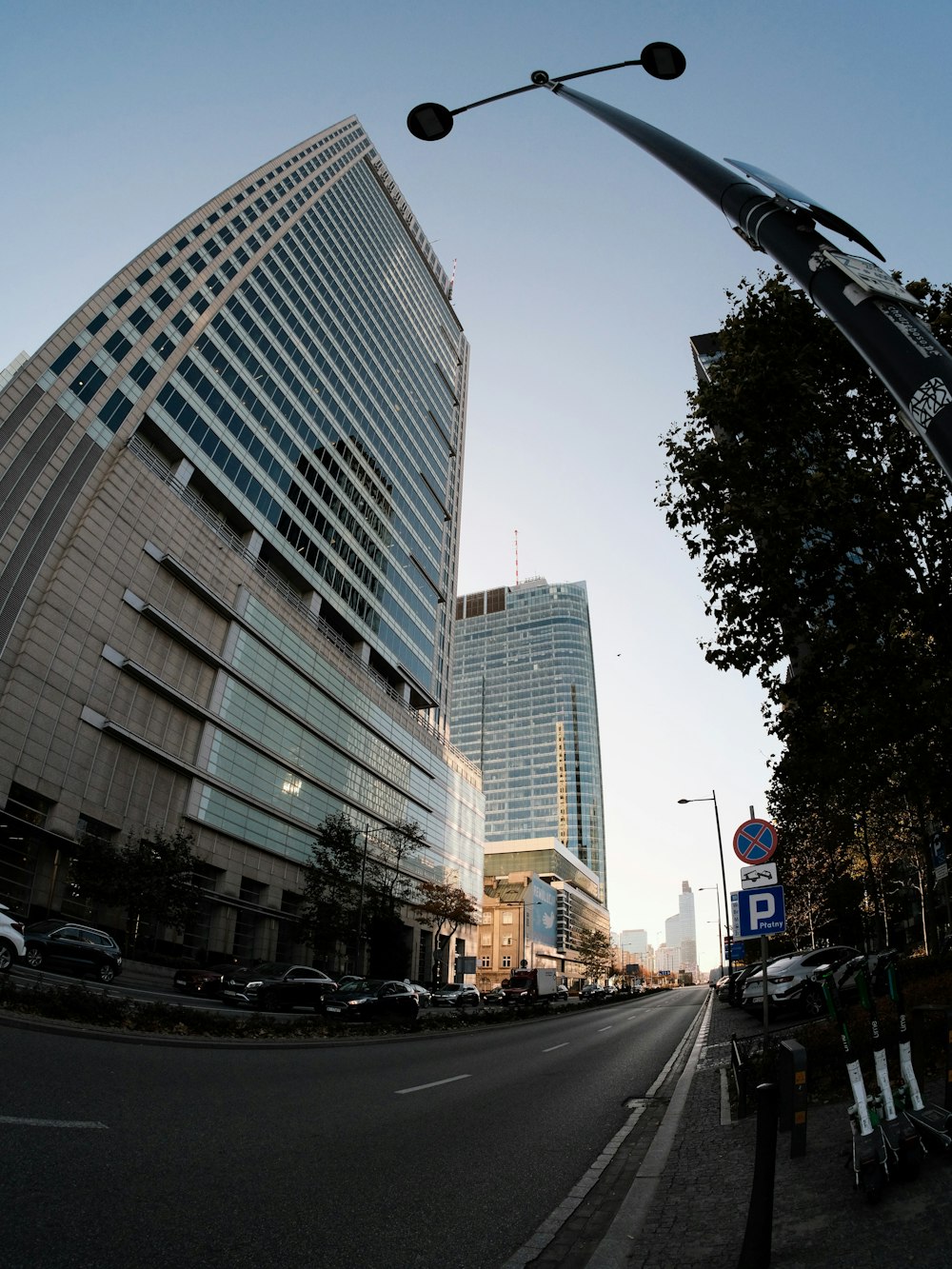 a city street with tall buildings in the background