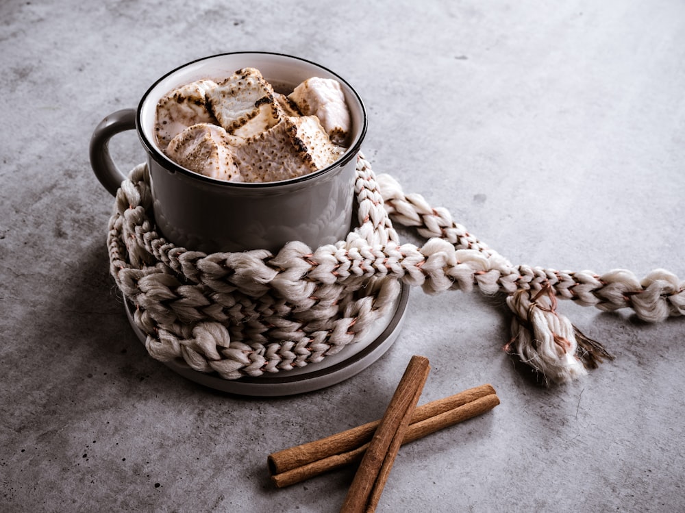 a cup of hot chocolate and cinnamon sticks