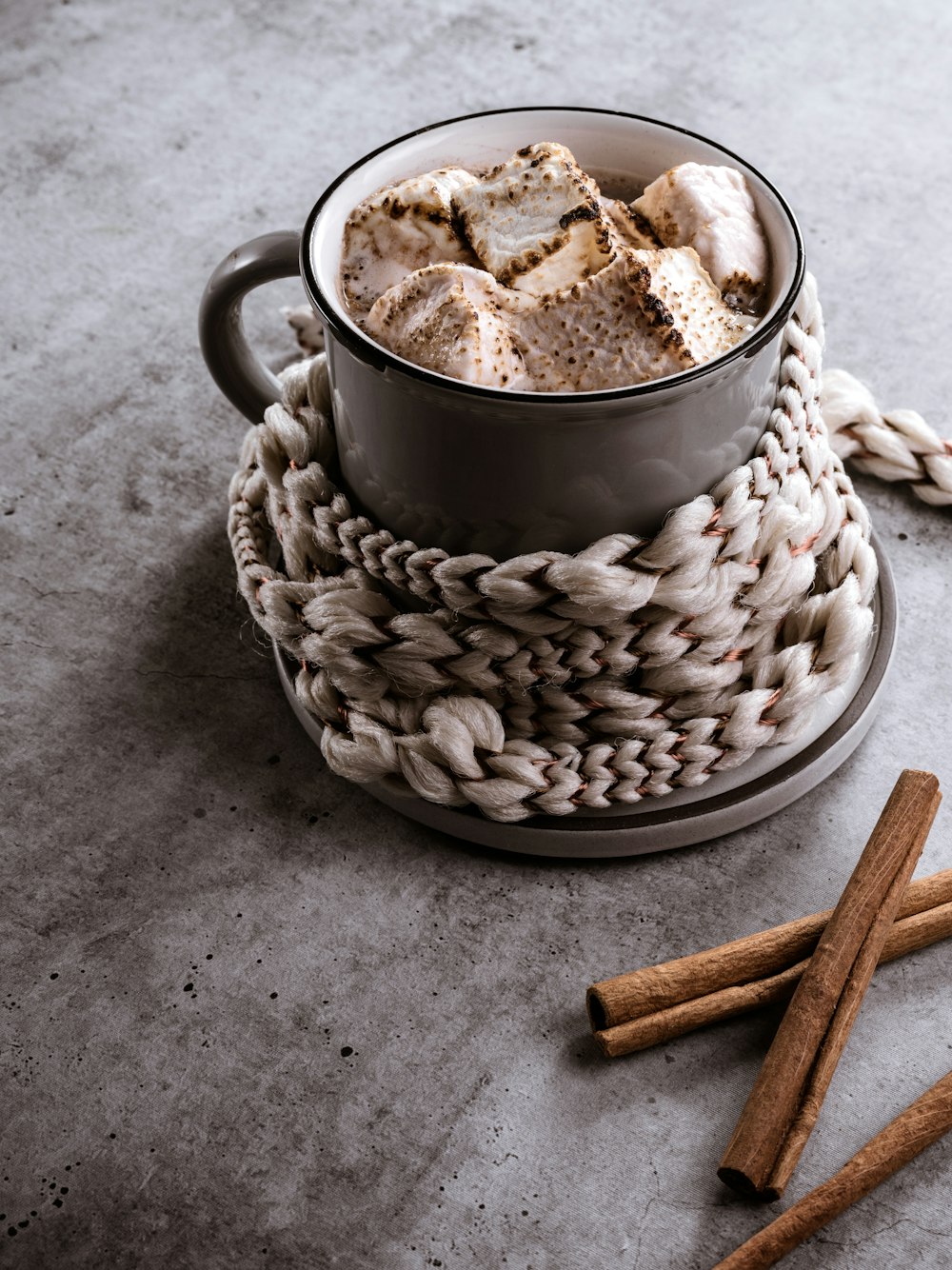 a cup of hot chocolate and cinnamon sticks