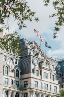 a large building with two flags on top of it