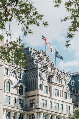 a large building with two flags on top of it