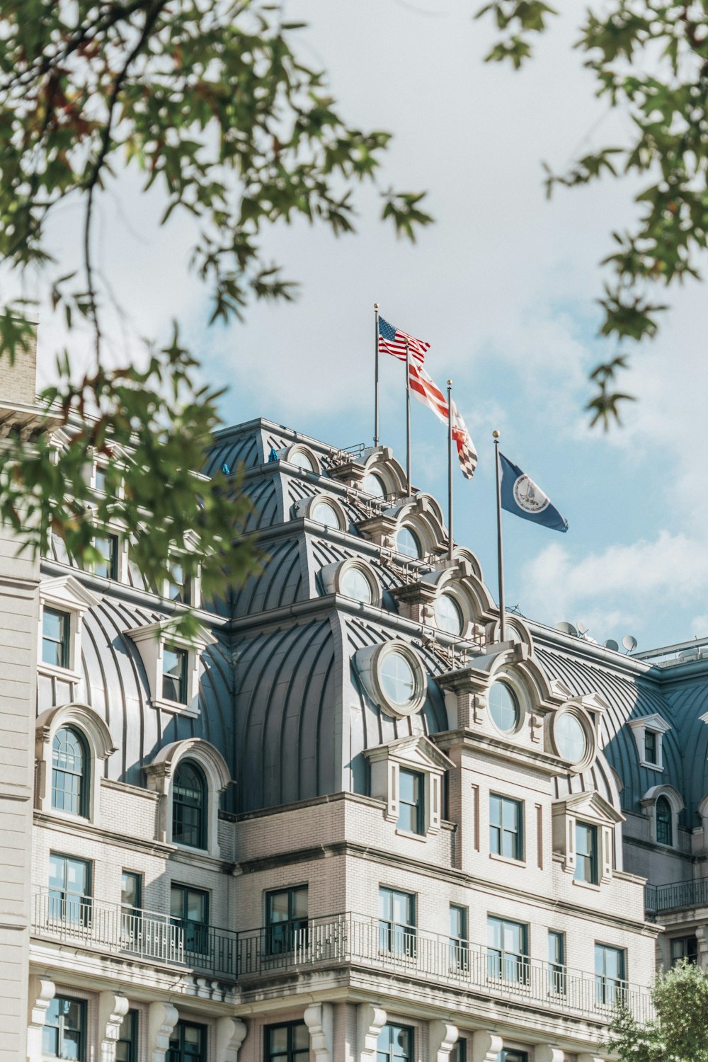 a large building with two flags on top of it