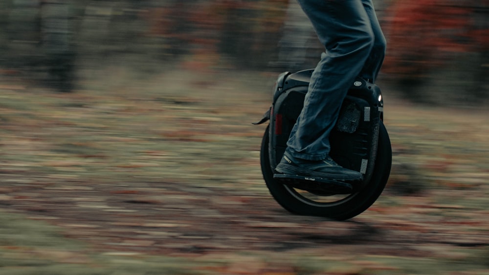 a person riding a scooter in the woods
