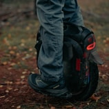 Customer happily testing a newly repaired electric unicycle outdoors.