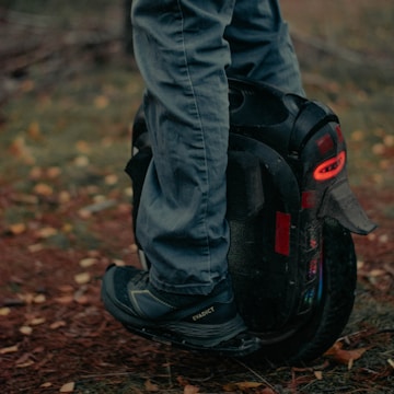 Customer happily testing a newly repaired electric unicycle outdoors.