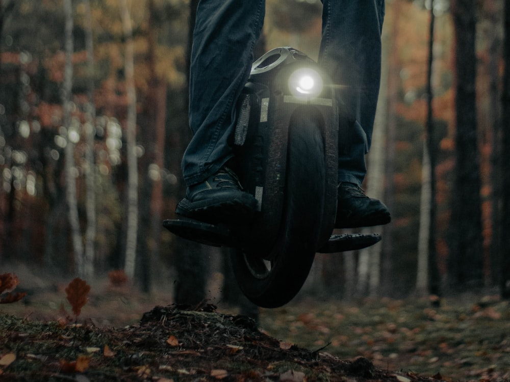 a person is riding a bicycle in the woods