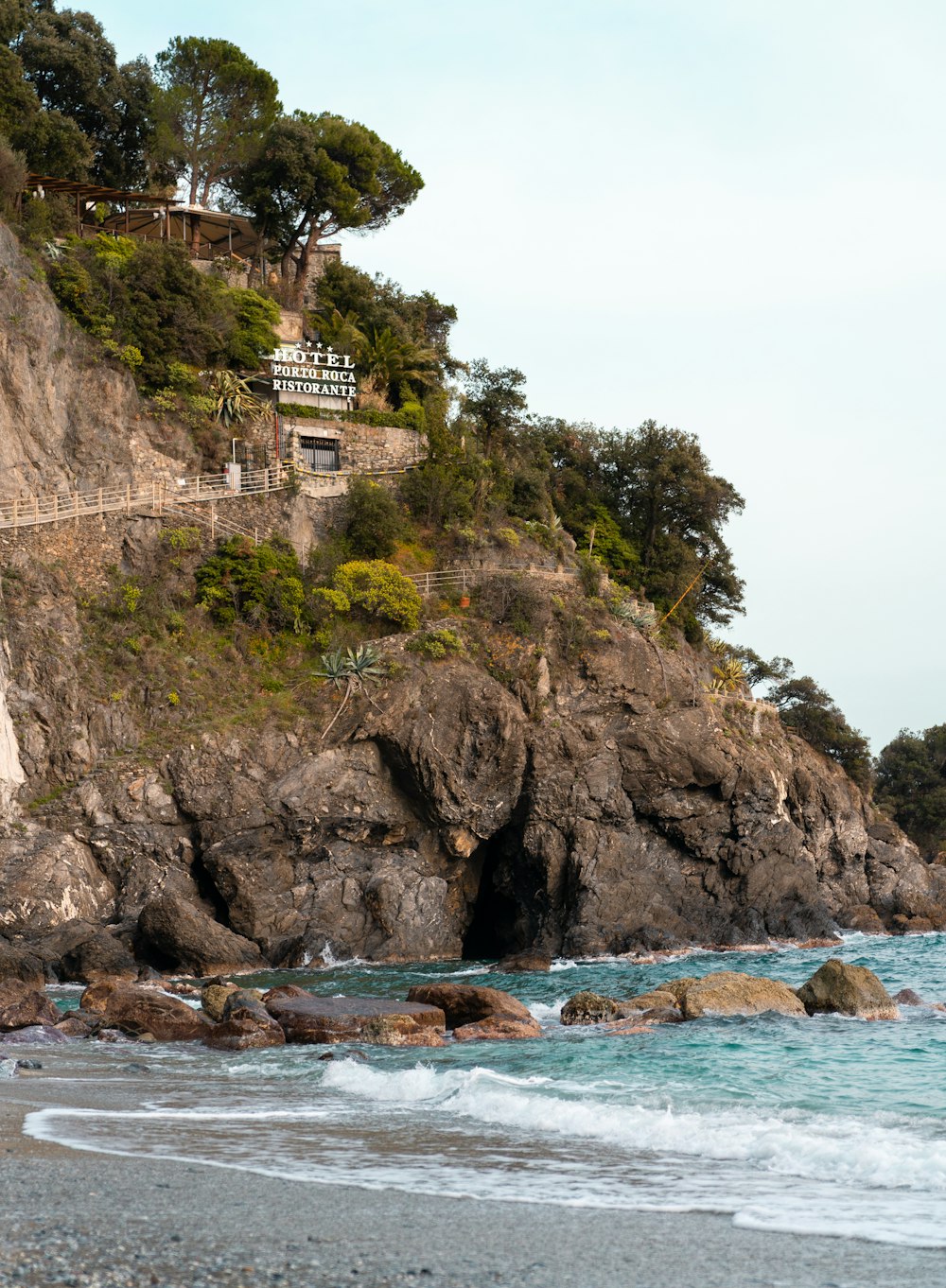 a rocky cliff with a sign on top of it