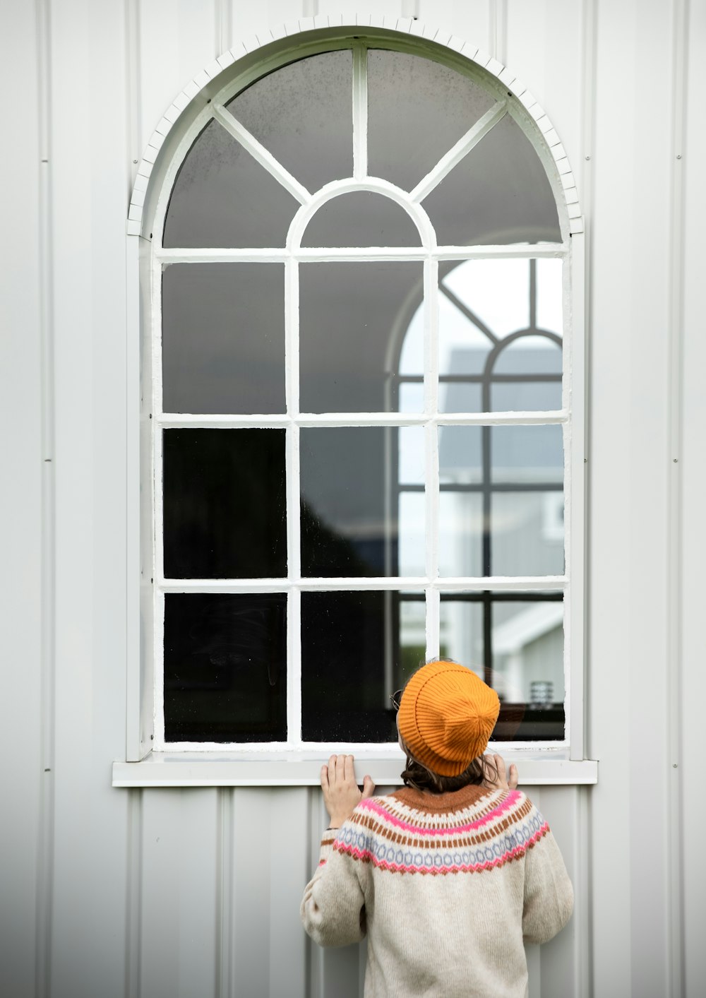 a little girl looking out of a window