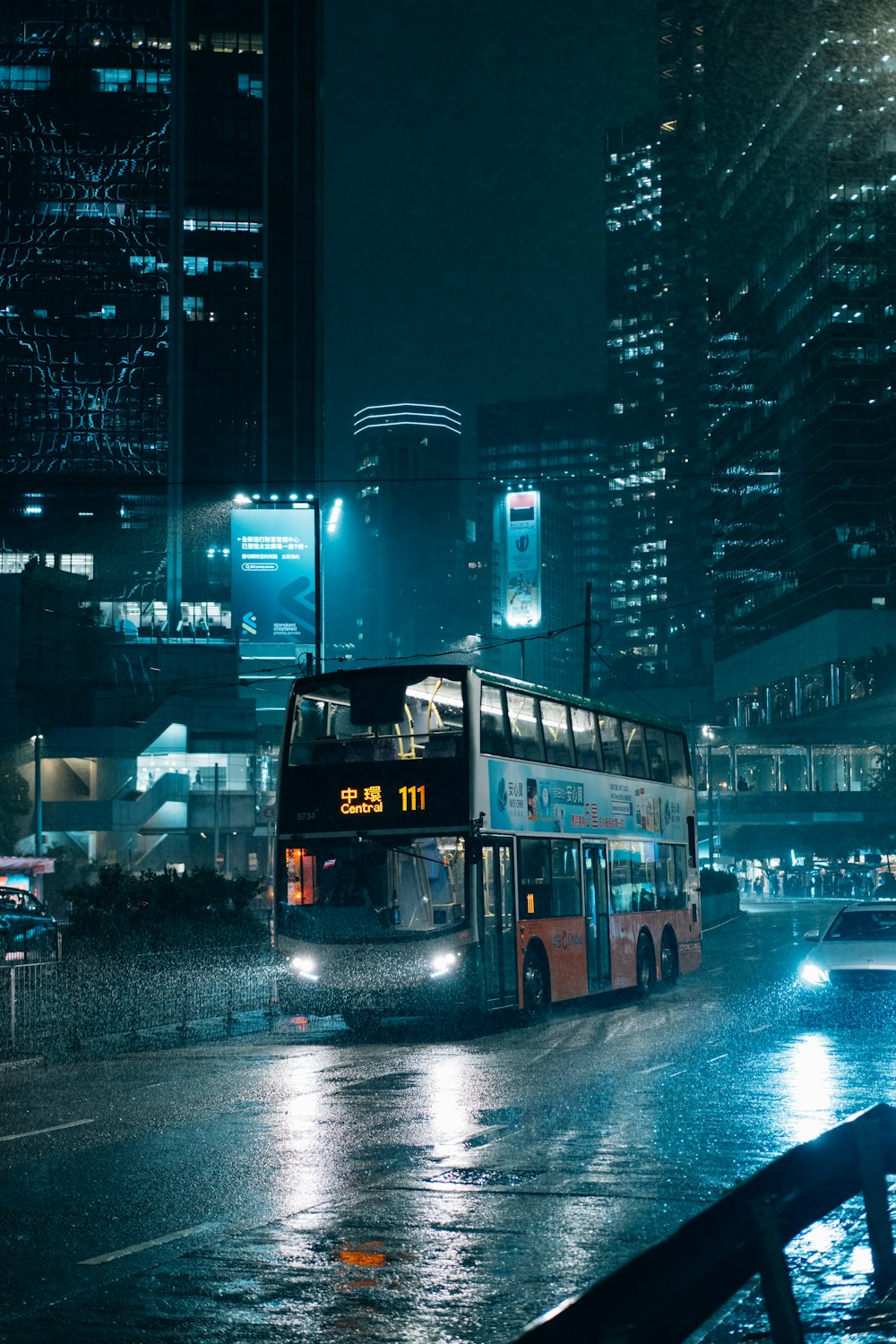 a double decker bus on a city street at night