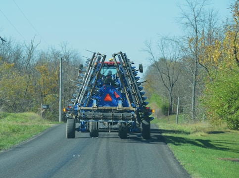 Oversized agricultural equipment loaded on a specialized trailer.