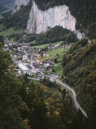 Scenic mountain village nestled among green hills and winding roads.