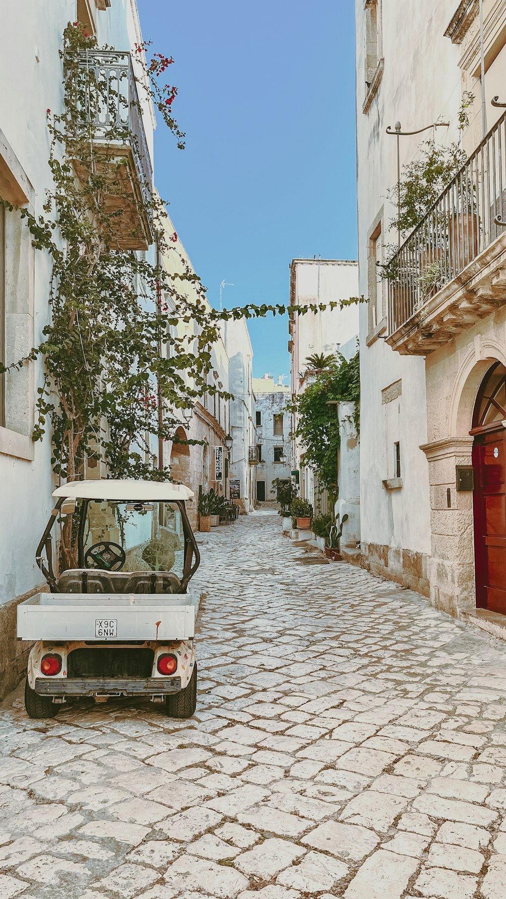 a small car parked on a cobblestone street