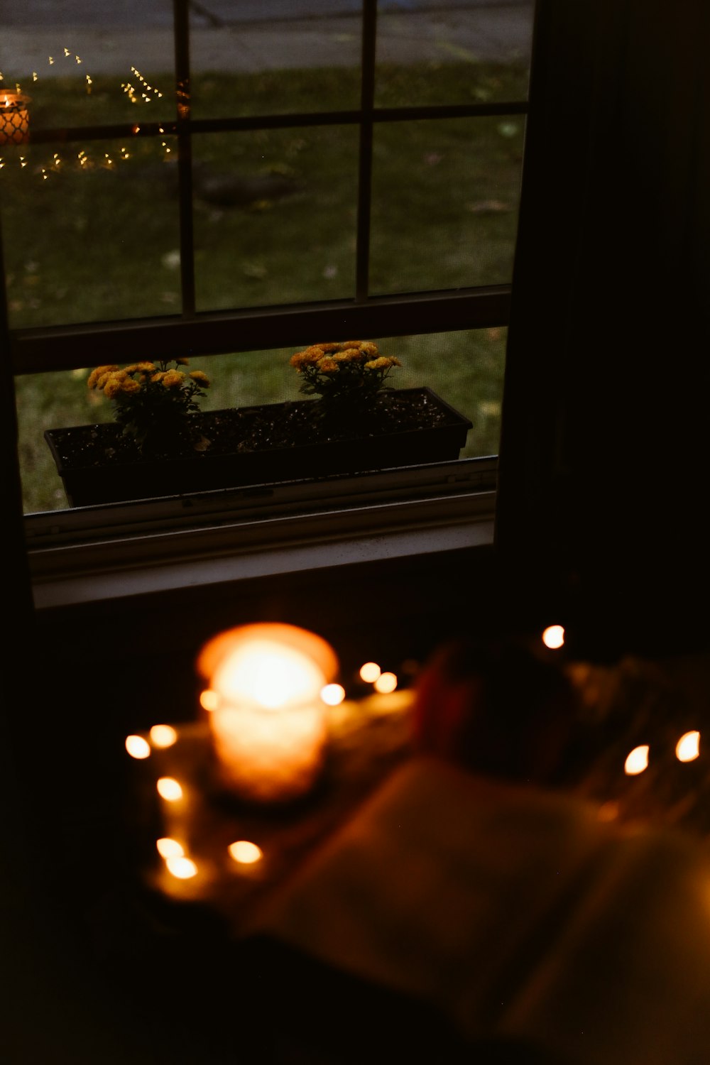 a candle is lit in front of a window