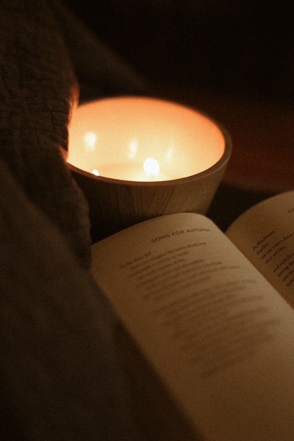 An open book beside a lit candle