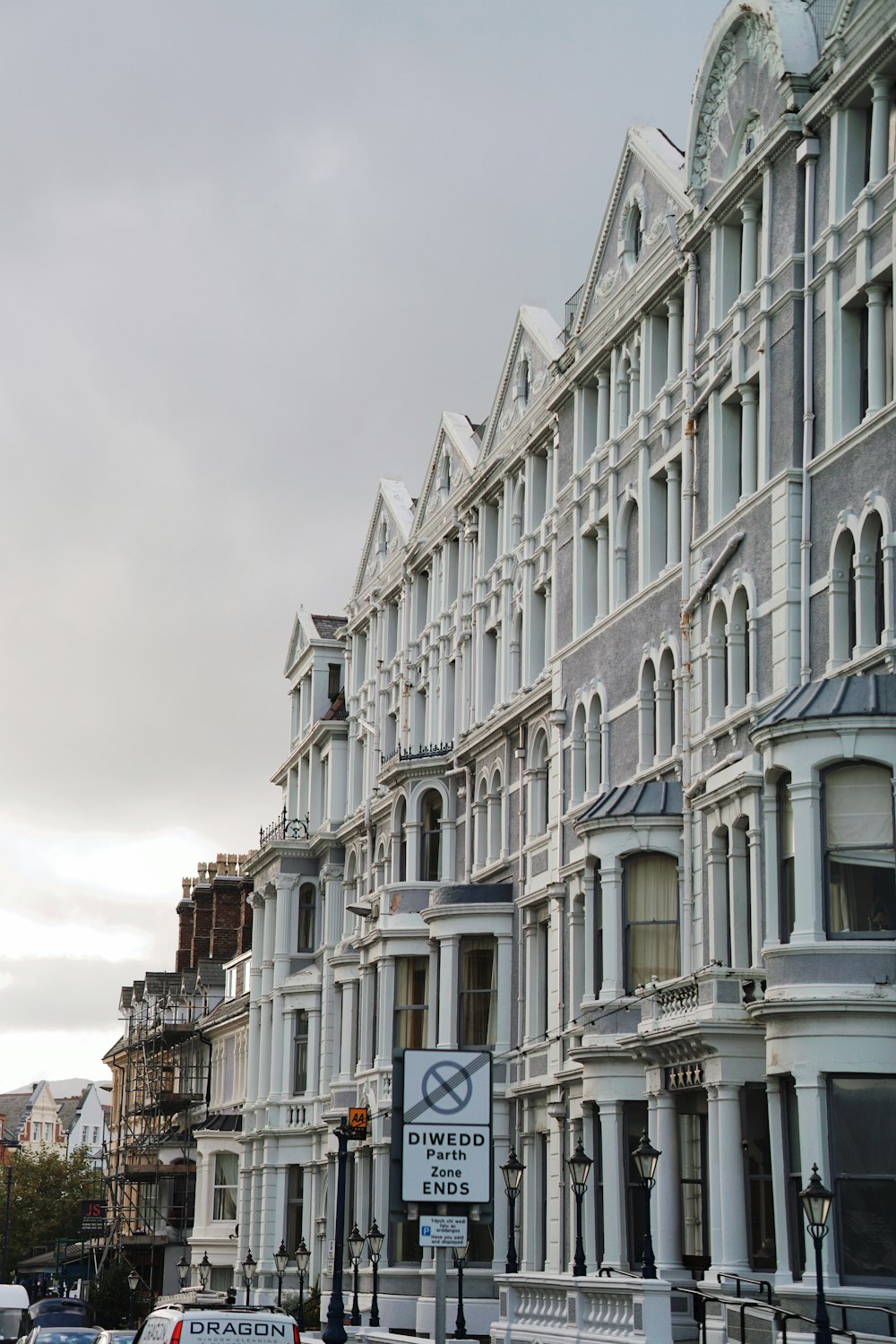 a row of white buildings on a city street