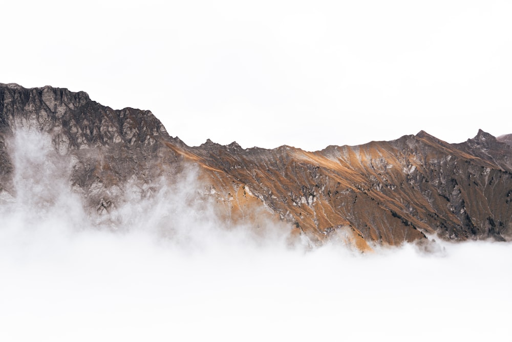 a view of a mountain range covered in clouds