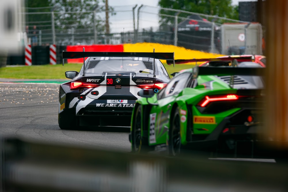 two racing cars driving on a race track