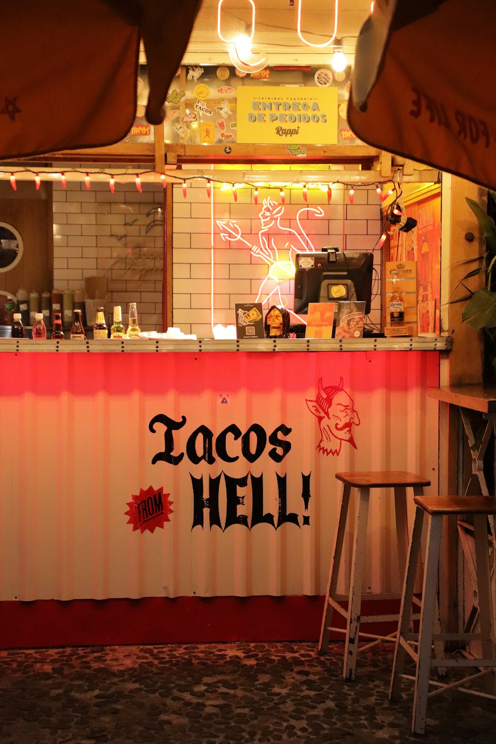 a bar with a sign that says tacos hell