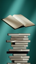 an open book sitting on top of a stack of books