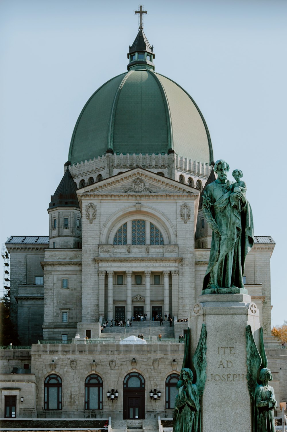a large building with a dome and a statue in front of it