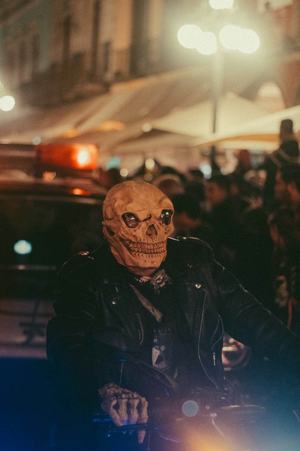a man in a skeleton mask riding a motorcycle